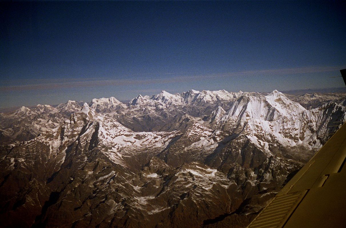 Kathmandu Mountain Flight 04-2 Gauri Shankar, Menlungtse And Lobuche Kang 1997 On my first Kathmandu Mountain Flight in 1997, I had an excellent view of both Gauri Shankar and Menlungtse. The ridge closer than Menlungtse has Menlung La, Chekigo (6257m), and Kang Nachugo (6735m) on the far right. Beyond Menlungtse in Tibet is the Labuche Kang massif. On the left is Peak 6952m, in the centre the slim silhouette of Labuche Kang II (7072m), and on the right Labuche Kang I (7367m), highest point of the massif.